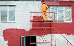 Exterior wall painting from scaffolding for even coverage and safety