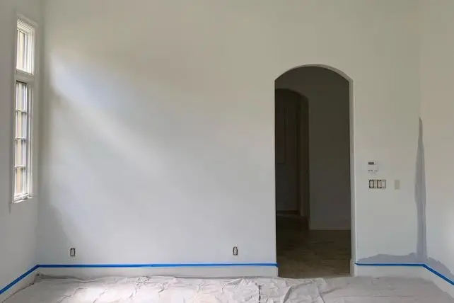 Interior room painting service during professional preparation and painting process