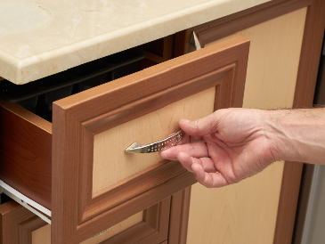 Final inspection of cabinet drawers and hardware after refinishing