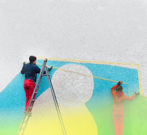 Professional exterior painters marking a stucco wall before residential painting work